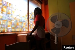 Nigerian ex-prostitute "Beauty" (a pseudonym), poses in a social support center for trafficked girls near Catania in Italy.