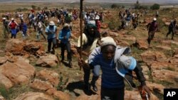 Miners sing as during their strike at the AngloGold Ashanti Mine in Fochville, near Johannesburg, South Africa on Oct. 18, 2012. 