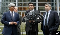 Luis Cortes, center, an attorney for Daniel Ramirez Medina, talks to reporters in Seattle, as fellow attorneys, from left, Theodore Boutrous Jr., Ethan Dettmer and Mark Rosenbaum, listen, March 8, 2017. Medina, a Seattle-area man, was arrested in February and detained by immigration agents despite his participation in a federal program to protect those brought to the U.S. illegally as children.