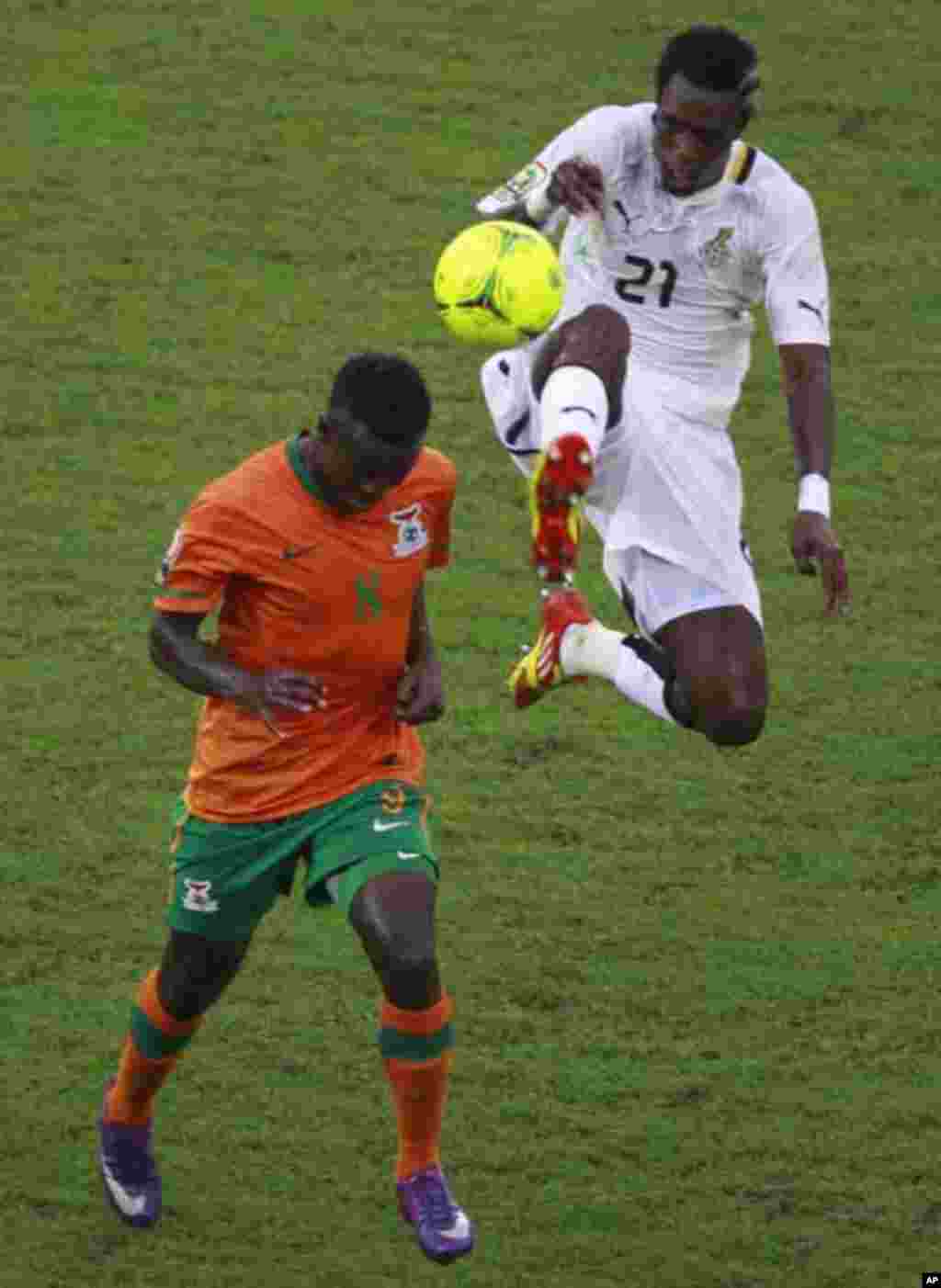 Isaac Chansa (bottom) of Zambia fights for the ball with John Boye of Ghana during their African Nations Cup semi-final soccer match at Estadio de Bata "Bata Stadium" in Bata February 8, 2012.
