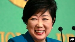 FILE - Tokyo Gov. Yuriko Koike smiles during a news conference at the Japan National Press Club in Tokyo, Sept. 28, 2017.