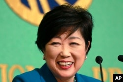 Tokyo Gov. Yuriko Koike smiles during a press conference at the Japan National Press Club in Tokyo, Sept. 28, 2017.