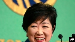 FILE - Tokyo Gov. Yuriko Koike smiles during a news conference at the Japan National Press Club in Tokyo, Sept. 28, 2017.