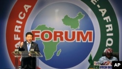 FILE - Chinese President Xi Jinping, left, delivers his speech during the opening ceremony of the Johannesburg Summit for the Forum on China-Africa Cooperation at the Sandton Convention Centre in Johannesburg, Dec. 4, 2015. 