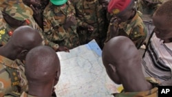 FILE - Soldiers from the Sudan People's Liberation Army (SPLA) are seen examining a map in Pana Kuach, Unity State, South Sudan.