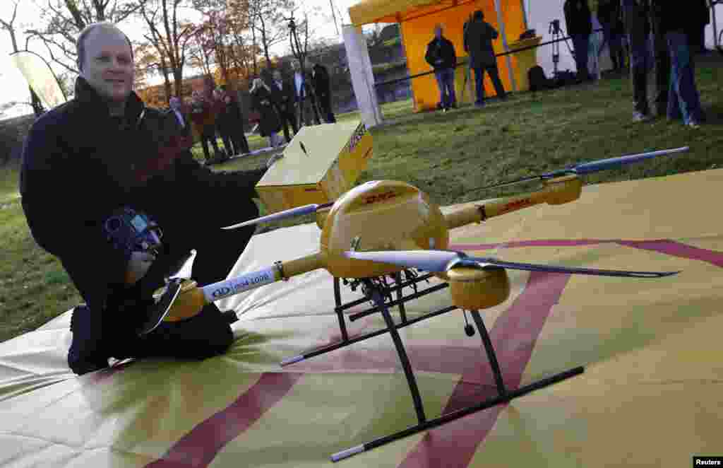 Microdrone pilot Daniel Knoche poses with the prototype of a "parcelcopter" of German postal and logistics group Deutsche Post DHL in Bonn, Germany, Dec. 9, 2013. 