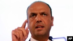 FILE - Italian Interior Minister Angelino Alfano speaks at a press conference during an informal meeting on Justice and Home Affairs in Milan, Italy, July 2014.