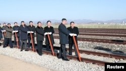 South and North Korean officials attend a groundbreaking ceremony for the reconnection of railways and roads at the Panmun Station in Kaesong, North Korea, Dec. 26, 2018. (Yonhap via Reuters)
