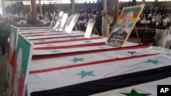 Mourners attend a mass funeral for those killed July 25, 2018, in suicide bombings launched by the Islamic State in the southern province of al-Sweida, Syria. At least 30 people were abducted and the Syrian Observatory for Human Rights reported that one o