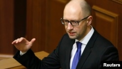 Ukraine's Prime Minister Arseny Yatseniuk speaks to deputies as he presents a work plan of his government during a parliament session in Kyiv, Dec. 11, 2014. 