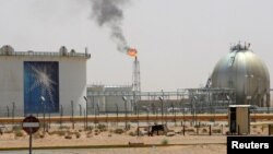 FILE - A gas flame is seen in the desert near the Khurais oilfield, about 160 km (99 miles) from Riyadh, Saudi Arabia, June 23, 2008.