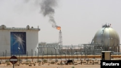 FILE - A gas flame is seen in the desert near the Khurais oilfield, about 160 km (99 miles) from Riyadh, Saudi Arabia, June 23, 2008.