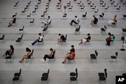 FILE - People wait 15 minutes after receiving the Pfizer COVID-19 vaccine during national COVID-19 vaccination campaign in Pamplona, northern Spain, Sept. 2, 2021.