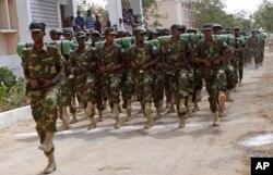 FILE - Somali soldiers march during the 54th anniversary of Somali National Army Day in Mogadishu, Somalia, April,12, 2014.