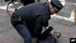 A policeman arrests a Occupy Wall Street protester in New York, Thursday, Nov. 17, 2011