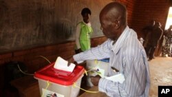 FILE - A man casts his ballot during elections in Bangui, Central African Republic, Dec. 30, 2015.