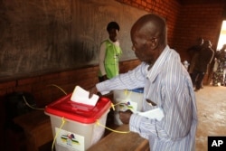 A man casts his ballot during elections in Bangui, Central African Republic, Dec. 30, 2015.