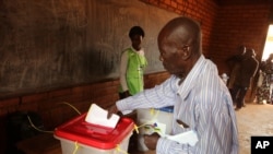 A man casts his ballot during elections in Bangui, Central African Republic, Dec. 30, 2015.