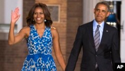 President Barack Obama and first lady Michelle Obama arrive for the Marine Barracks Evening Parade, Friday, June 27, 2014, in Washington