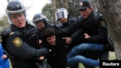 Police officers detain a man during a rally in Baku, Azerbaijan, Jan. 26, 2013. In addition to arresting 20 activists in 2016 on "spurious charges," the Azeri government has severely limited the ability of independent groups to function, a news Human Right Watch report says.