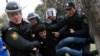FILE - Police officers detain a man during a rally in Baku, Azerbaijan, Jan. 26, 2013. Azerbaijan has decided to give amnesty to over 400 people, including a number of political activists and journalists.