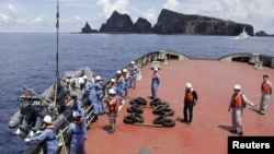 Workers on the city government of Tokyo's survey vessel prepare to survey around a group of disputed islands known as Senkaku in Japan and Diaoyu in China in the East China Sea September 2, 2012. The city government of Tokyo sent a ship to survey a group 