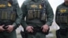 U.S. Border Patrol agents watch as President Donald Trump visits the banks of the Rio Grande River in Mission, Texas, Jan. 10, 2019. 