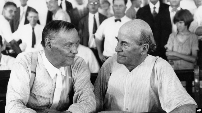 Clarence Darrow, left, and William Jennings Bryan speak with each other at the "monkey trial" in Dayton, Tenn. in 1925.