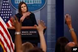White House press secretary Sarah Huckabee Sanders calls on a reporter during the daily press briefing, Aug. 1, 2017, at the White House in Washington.