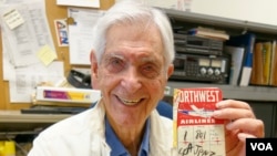 Irwin "Sonny" Fox holds his airline ticket to Tokyo from 1952, March 29, 2015. (VOA / M. O'Sullivan)
