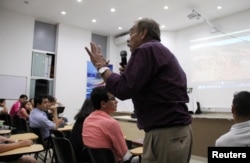 A resident speaks to fellow residents at a community meeting about AngloGold Ashanti's La Colosa project in Ibague, Colombia, Aug. 25, 2016.