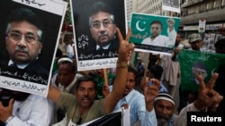 FILE - Supporters of former President Pervez Musharraf, head of the All Pakistan Muslim League (APML) political party, chant slogans during a protest demanding to remove his name from exit control list (ECL), so he can travel abroad to visit his ailing mother, in Karachi.