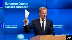 European Council President Donald Tusk holds the document from the United Kingdom at the Europa building in Brussels, March 29, 2017. Tusk has received a letter from British Prime Minister Theresa May, invoking Article 50 of the bloc's key treaty, the formal start of exit negotiations. 