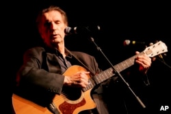FILE - Actor Harry Dean Stanton performs at the 35th anniversary celebration of the founding of Greenpeace in Los Angeles, Sept. 9, 2006.