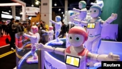 FILE - Avatarmind's iPal Smart AI Robots, designed to be companions for children and elderly, perform calisthenics during the 2018 CES in Las Vegas, Nevada, Jan. 9, 2018.