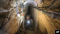 An Israeli army officer shows journalists a tunnel allegedly used by Palestinian militants for cross-border attacks from Gaza into Israel, July 25, 2014.