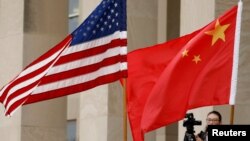 FILE - U.S. and Chinese flags fly at the Pentagon in Arlington, Virginia, November 9, 2018.