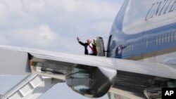 FILE - President Donald Trump waves as he boards Air Force One. 