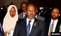 Somali's former president Hassan Sheikh Mohamud is escorted as he leaves a meeting in Ethiopia's capital Addis Ababa, Jan. 30, 2017.