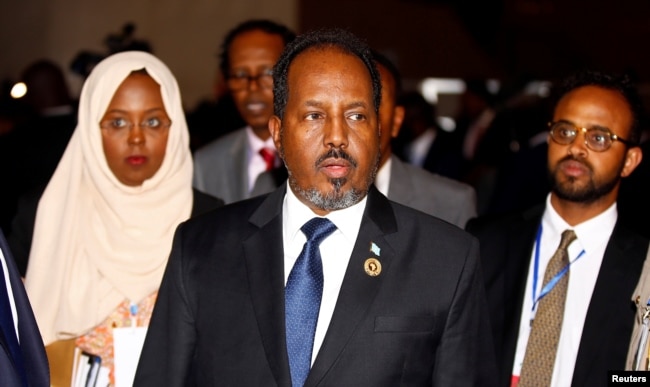 Somali's former president Hassan Sheikh Mohamud is escorted as he leaves a meeting in Ethiopia's capital Addis Ababa, Jan. 30, 2017.