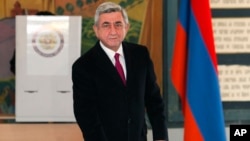 Armenian President Serge Sarkisian casts his ballot during presidential election in Yerevan, Armenia, Feb. 18, 2013.