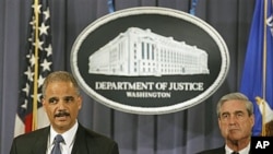 Attorney General Eric Holder (L) accompanied by FBI Director Robert Mueller, announced that two men have been charged in New York for their alleged participation in a plot directed by the Iranian government to murder the Saudi Ambassador to the United Sta