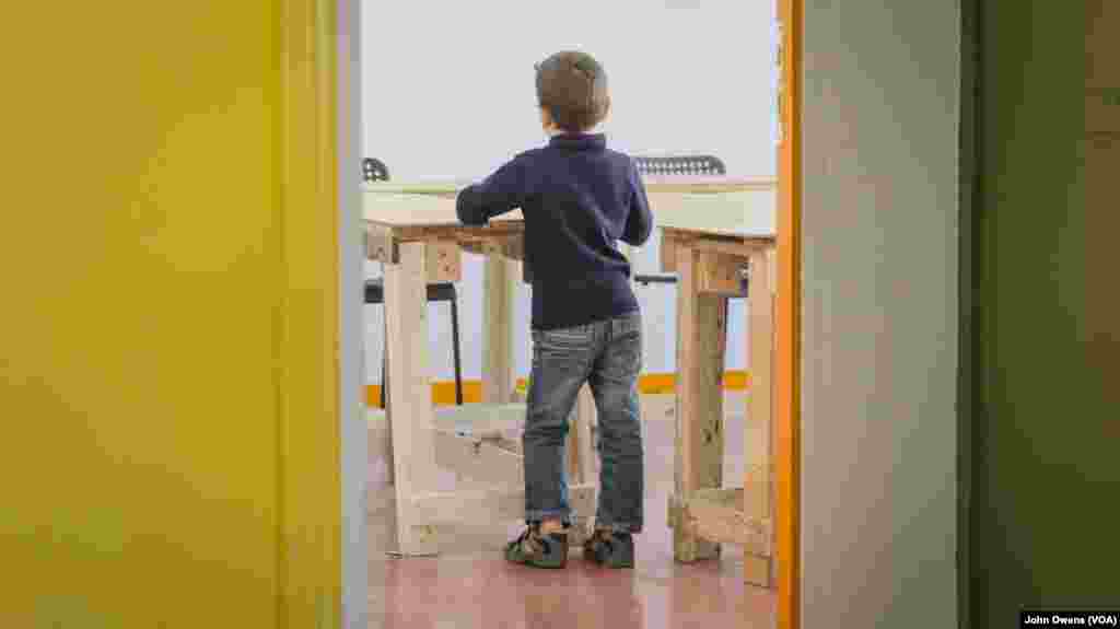 A youngster is shown in one of the Khora center’s classrooms, where Greek and English language lessons are taught, in the Exarchia district in Athens, Greece, Oct. 24, 2016.