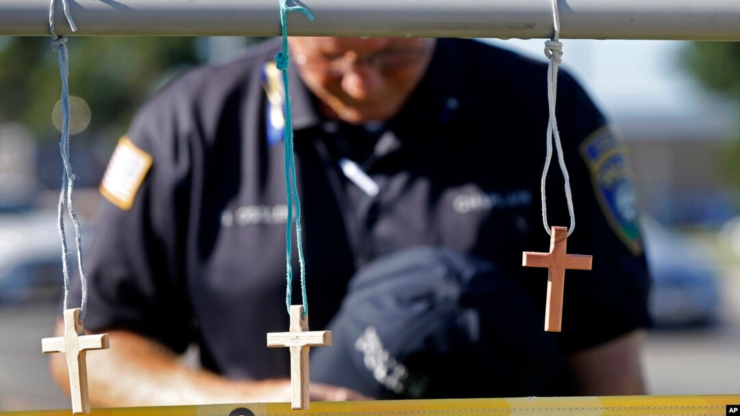 A police chaplain pays his respects July 18, 2016, at a makeshift memorial at the fatal shooting scene in Baton Rouge, Louisiana, where three law enforcement officers were ambushed and killed by a lone gunman on Sunday.