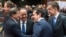 Turkish Prime Minister Ahmet Davutoglu, left, speaks with, from left, French President Francois Hollande, Greek Prime Minister Alexis Tsipras and Estonian Prime Minister Taavi Roivas during a meeting at an EU summit in Brussels, March 18, 2016. 