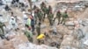 FILE — Zambian Army special forces officers follow the rescue operation of miners in Chingola, Dec. 3, 2023 