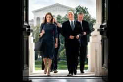 FILE - Judge Amy Coney Barrett, President Donald Trump's nominee to the Supreme Court, and Vice President Mike Pence arrive at the Capitol where she was to meet with senators, Sept. 29, 2020.