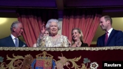 Britain's Queen Elizabeth waves next to Prince Charles and Prince William, Duke of Cambridge, during a special "The Queen's Birthday Party" concert to celebrate her 92nd birthday at the Royal Albert Hall in London, April 21, 2018.