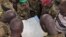 FILE - Soldiers from the Sudan People's Liberation Army (SPLA) are seen examining a map in Pana Kuach, Unity State, South Sudan.