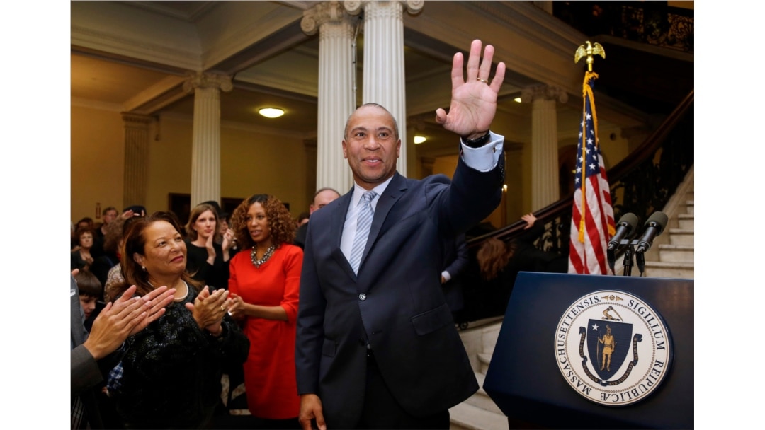 FILE - Massachusetts Gov. Deval Patrick, center, waves to people in the audience as his wife Diane Bemus, left, looks on at the conclusion of ceremonies for the unveiling of his official state portrait, Jan. 4, 2015, at the Statehouse, in Boston.